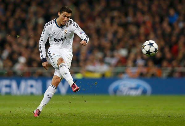 Real Madrid's Cristiano Ronaldo takes a free kick against Manchester United during the Champions League soccer match at Santiago Bernabeu stadium in Madrid